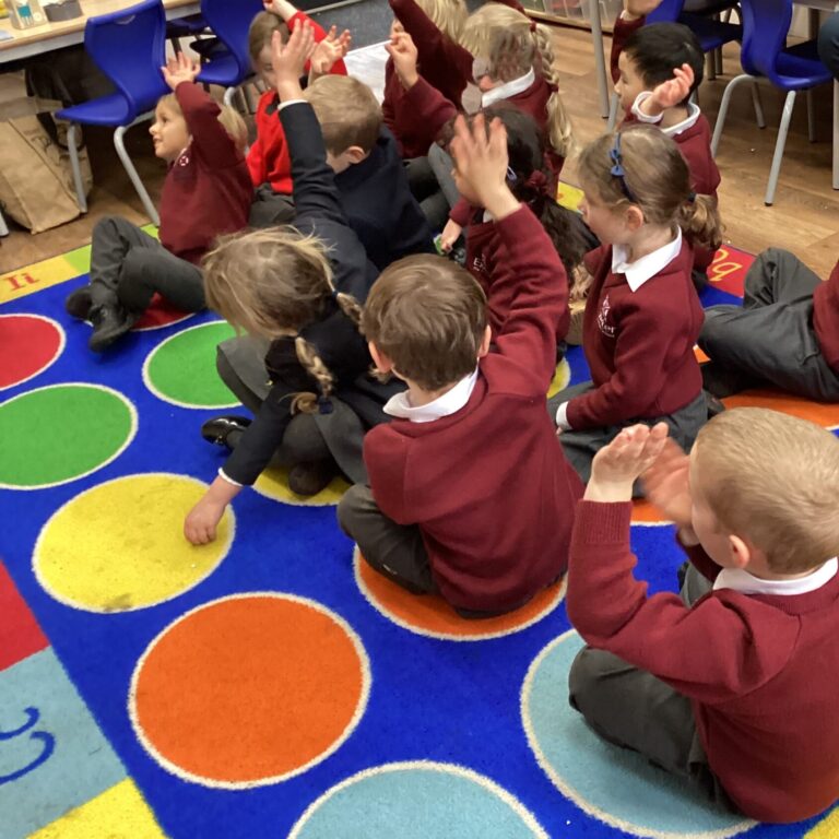 Students raising their hands in class