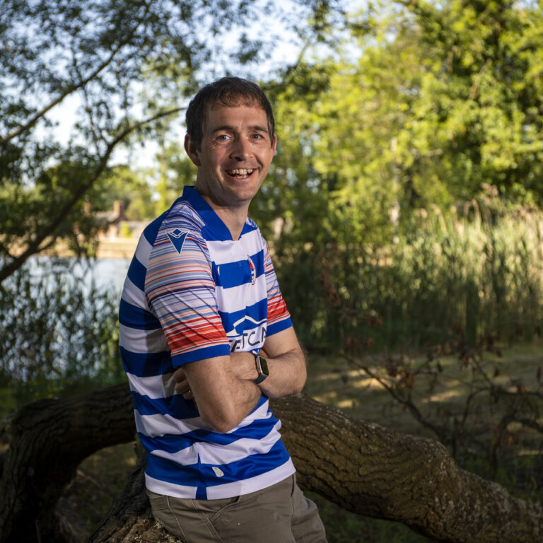 man leaning on a tree branch