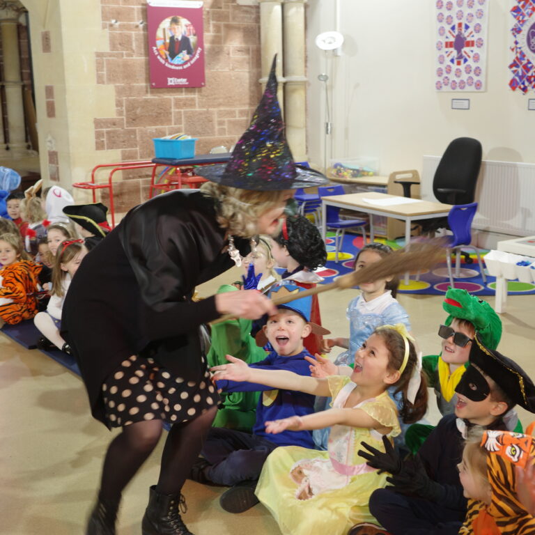 teacher dressed as a witch making pupils laugh