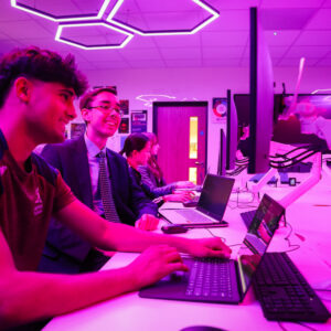 students in a pink lit room