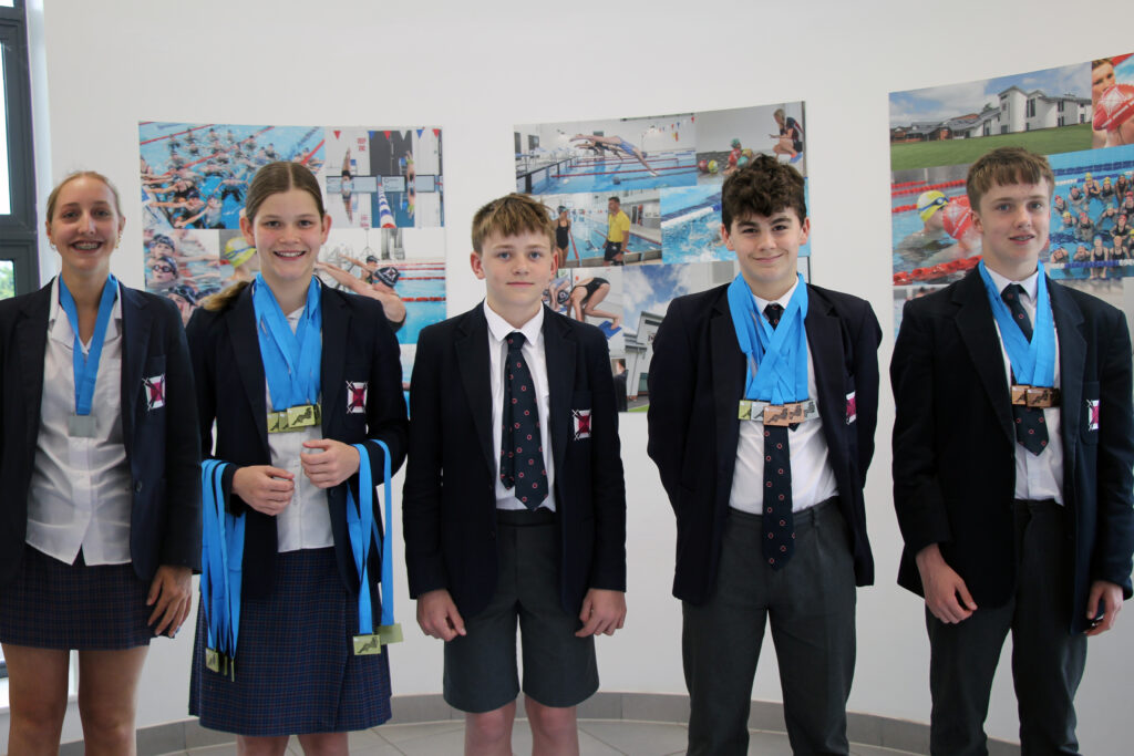 students holding medals