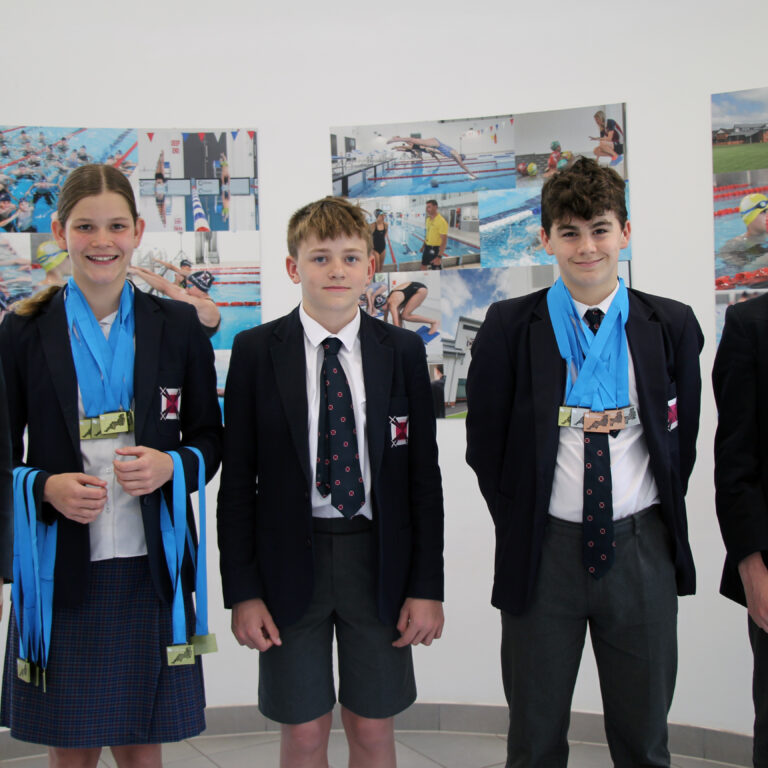 students holding medals