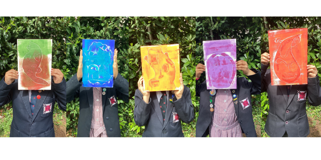 students holding up paintings