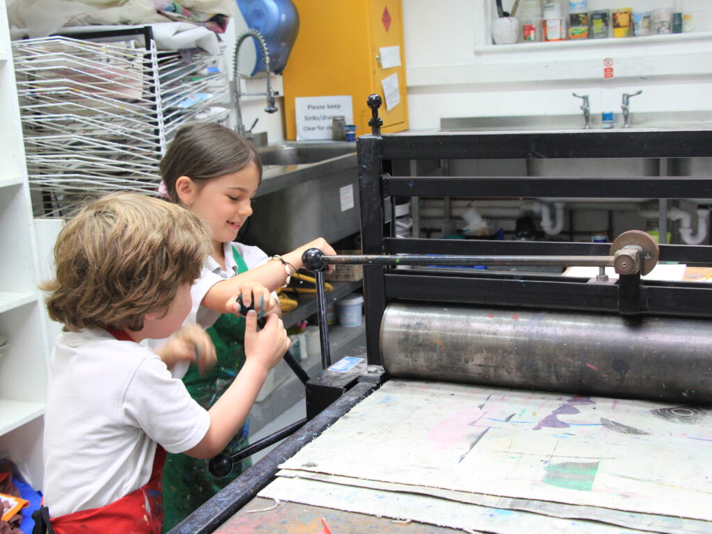 students using an art press