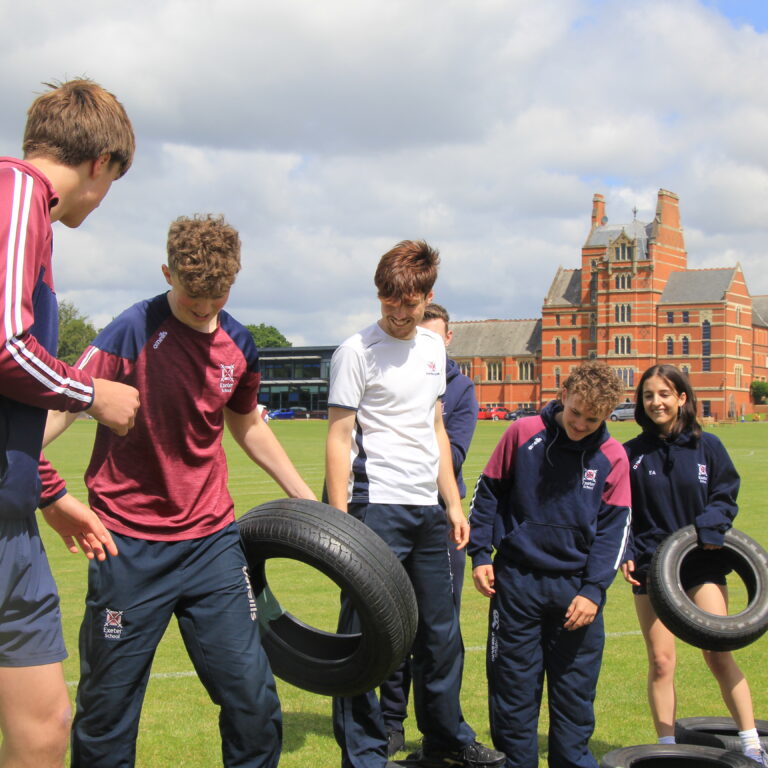 senior school students lifting tyres